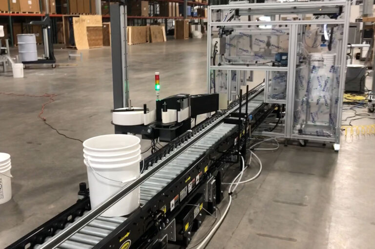 Automated Filling and Labeling process on automated conveyor container heading to scale