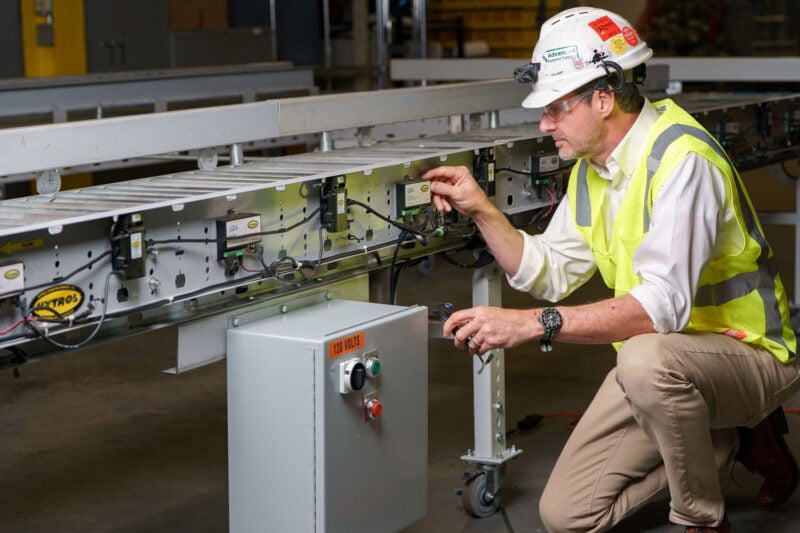 Conveyor engineer adjusting Hytrol conveyor systems controls.