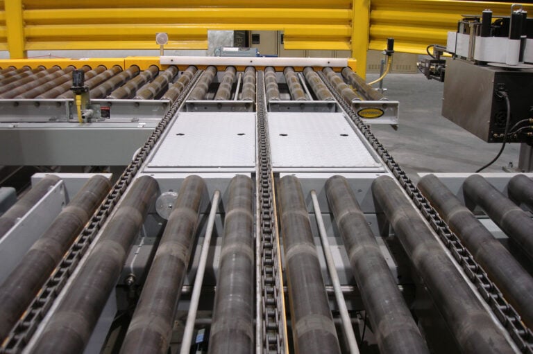 Pallet transfer conveyor for heavy equipment and pallets